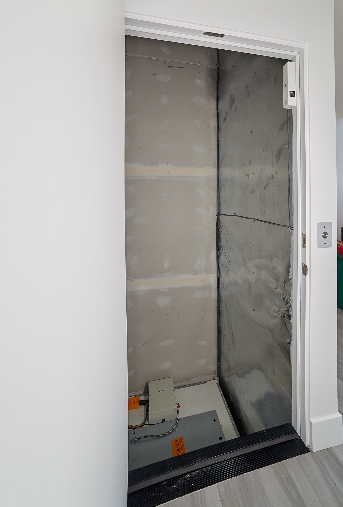 Elevator door closed flush with the wall Elevator door closed flush with the wall